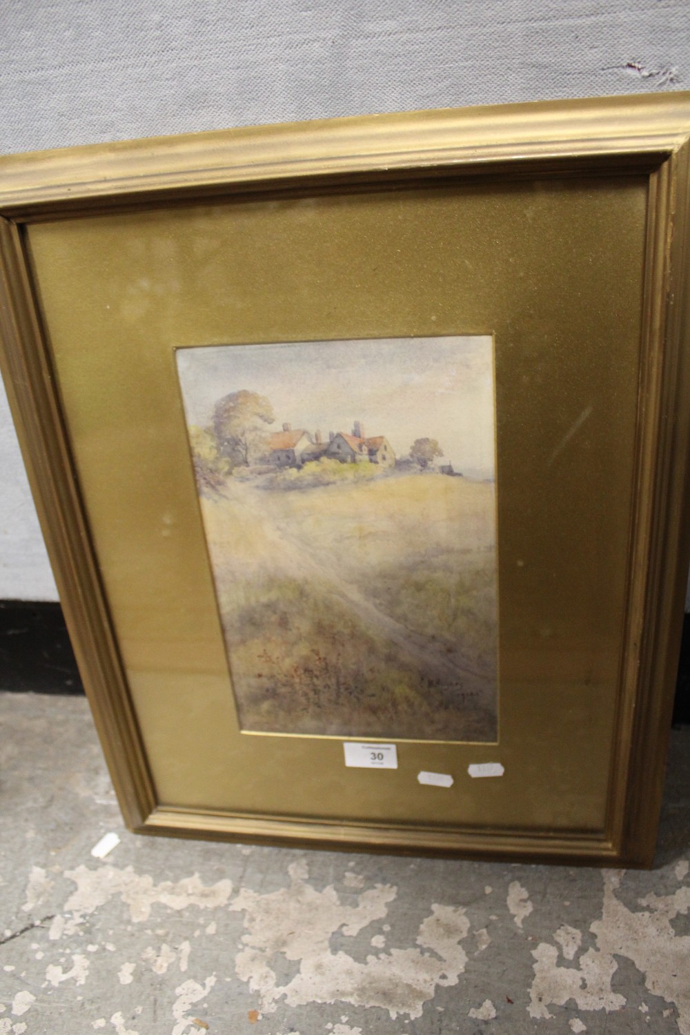 A GILT FRAMED AND GLAZED WATERCOLOUR DEPICTING A COUNTRY PATH BEFORE BUILDINGS SIGNED C H HUGHES