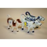 THREE CERAMIC COW CREAM JUGS TO INCLUDE A GOEBEL EXAMPLE