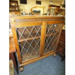 A REPRODUCTION CARVED OAK GLAZED BOOKCASE H-114 CM W-102 CM