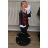 AN UNUSUAL BOTTLE HOLDER FIGURE, OF A "'MAITRE"' WAITER figure height 106 cm.