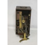 A 19TH CENTURY LACQUERED BRASS MONOCULAR MICROSCOPE, in fitted wooden case with a selection of