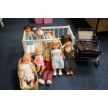 SEVEN LARGE VINTAGE DOLLS PLUS A DOLL IN A MOSES BASKET also including two dolls cots and a blue