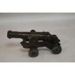 A SMALL ANTIQUE SIGNAL CANNON ON SHEET METAL CARRIAGE