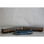 AN UNBOXED O GAUGE LIMA DIESEL LOCOMOTIVE and two unboxed LMS carriages.