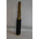 AN ANTIQUE BRASS & LEATHER THREE DRAW TELESCOPE, signed "'P Carpenter London, improved day or