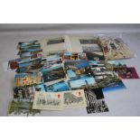 AN ALBUM OF POSTCARDS, along with a tin of loose cards and a selection of tea cards.