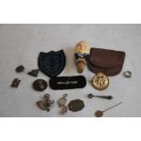 A CIGAR BOX OF COLLECTABLES, to include military badges, Trench Art rings, a Churchill bottle