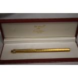 A CARTIER GOLD PLATED BALL POINT PEN IN FITTED BOX, with guarantee card and outer card slip box