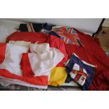 A QUANTITY OF VINTAGE FLAGS, to include three Union Jacks.