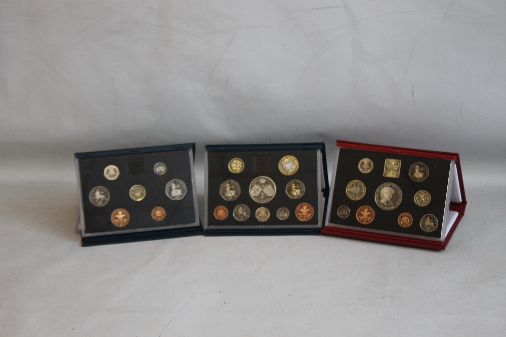 ROYAL MINT UK PROOF SETS, Red De-Luxe 1999 (includes Princess Diana Five pounds) and Blue sets