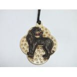 A CARVED AND PIERCED VICTORIAN TYPE IVORY PENDANT DECORATED WITH A LION, H 5.5 cm A/FCondition