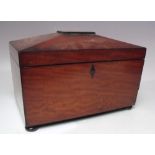 A 19TH CENTURY MAHOGANY SARCOPHAGUS SHAPED TEA CADDY, the hinged lid opening to a part fitted
