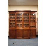 A LARGE MAHOGANY BREAKFRONT LIBRARY BOOKCASE, the upper section with four astragel glazed doors,