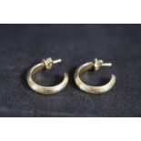 A PAIR OF THEO FENNELL 18 CARAT GOLD HALF HOOP EARRINGS, bearing full hallmarks and named on the