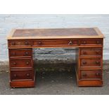 A MID VICTORIAN MAHOGANY TWIN PEDESTAL DESK, having an arrangement of nine drawers with fluted glass