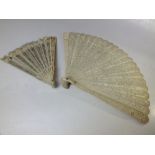 AN ANTIQUE CARVED BONE / IVORY BRISE FAN FOR RESTORATION, together with a smaller example, longest L