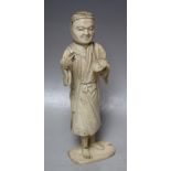 A JAPANESE CARVED IVORY OKIMONO, depicting an artist / scholar, the right hand with a missing