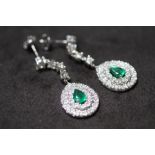 A PAIR OF 18ct WHITE GOLD PEAR DROP EMERALD AND DIAMOND CLUSTER DROP EARRINGS, boxed. Emeralds 1.