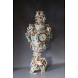 A LARGE AND IMPOSING CONTINENTAL CERAMIC TABLE CENTREPIECE LIDDED CLOCK URN, with typical figurative