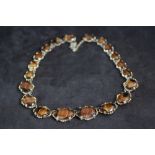 A VINTAGE TIGERS EYE STYLE AGATE NECKLACE, in a gilt mount