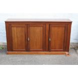 A 19TH CENTURY MAHOGANY SERVING SIDEBOARD, with three panelled doors, shelves to the interior, H