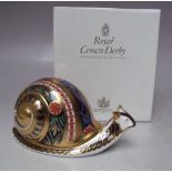 A ROYAL CROWN DERBY LIMITED EDITION 'GARDEN SNAIL' PAPERWEIGHT, number 95 of 4500, gold stopper,