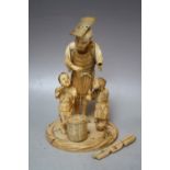 A JAPANESE IVORY OKIMONO, depicting a fisherman with two children with a fishing basket and loose