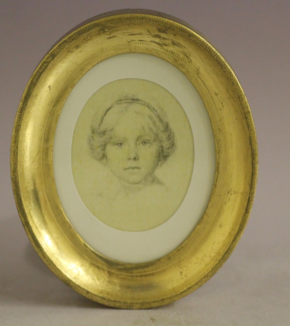 AN OVAL PORTRAIT MINIATURE ON SILK OF A YOUNG GIRL, unsigned, mixed media on silk, framed and