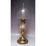 A 19TH CENTURY BRASS AND GLASS OIL LAMP, with circular and bulbous support leading to a cleat