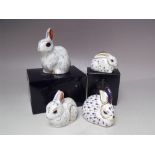 A COLLECTION OF FOUR ROYAL CROWN DERBY RABBIT PAPERWEIGHTS, comprising two boxes examples 'Snowy