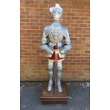 AN EMBOSSED STEEL CARLOS V FULL SIZE SUIT OF ARMOUR ON STAND, hand crafted in steel and iron, the