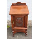 A SMALL EDWARDIAN CARVED MAHOGANY BEDSIDE CUPBOARD, the carved shaped supports united by an under