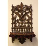 A CARVED OAK BLACK FOREST STYLE FOLDING WALL BRACKET, H 54.5 cm