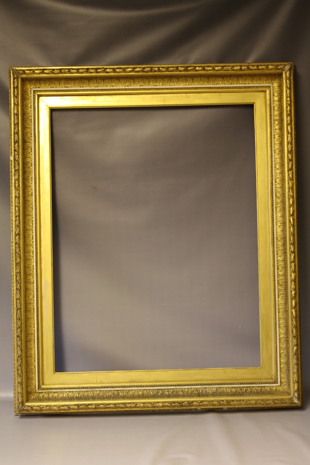 (XIX). Gold frame with acanthus leaf design to outer edge and gold slip, frame W 10 cm, frame rebate