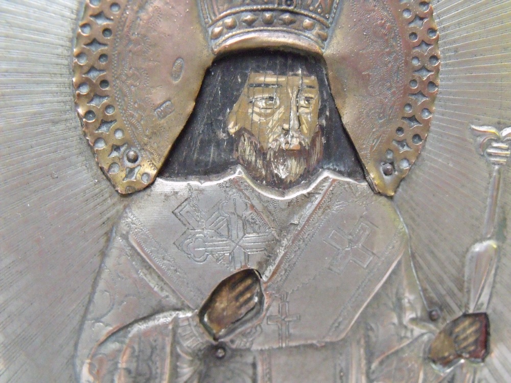 (XIX). A religious icon on panel with exposed head and hands and white metal oklad with acrylic - Image 2 of 4