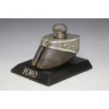 A TAXIDERMY WHITE METAL MOUNTED HOOF, on an ebonised plinth initialled KMO, W 15 cm
