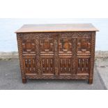 AN ANTIQUE OAK JACOBEAN STYLE DEEP COFFER, the hinged lift-up lid above a carved and moulded