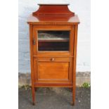 AN EDWARDIAN MAHOGANY INLAID MUSIC CABINET, having a small glazed door above a pull-out panelled