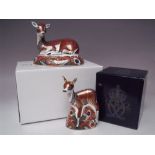 A ROYAL CROWN DERBY COLLECTORS GUILD 'DEER' PAPERWEIGHT, together with a 'Fawn' paperweight, both