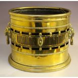A LARGE ANTIQUE BRASS OVAL COAL BIN, pierced gallery, twin lion head ring turned handles, with