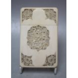 A CIRCA 1900 CHINESE CANTON IVORY CARD CASE, having shaped and relief carved opposing panelled