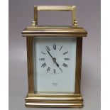 A BRASS CASED CARRIAGE CLOCK BY HUBER OF LONDON, white enamel dial with Roman numerals, movement
