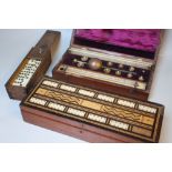 A MAHOGANY CASED GAMES COMPENDIUM, cased hydrometer and a cased set of dominoes (3)