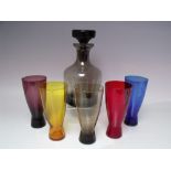 A STUDIO GLASS DECANTER WITH FIVE SHAPED HARLEQUIN TUMBLERS, together with a selection of studio