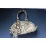 A JUST CAVALLI GOLD LEATHER HANDBAG, two loop handles, with gold-tone detail throughout, tasseled