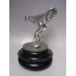 A VINTAGE CHROMED STATUETTE / CAR MASCOT OF 'THE SPIRIT OF ECSTASY', raised on a circular base,