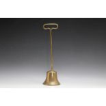 A BRASS DOOR STOP IN THE FORM OF A BELL, H 37 cm