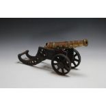 A BRONZE AND CAST IRON MODAL OF A CANON, W 45 cm
