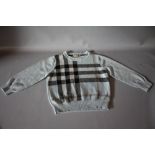 A CHILDS VINTAGE BURBERRY JUMPER, pale blue with traditional Burberry design