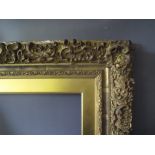 A 19TH CENTURY DECORATIVE GOLD FRAME WITH GOLD SLIP A/F, frame W 10 cm, frame rebate 58 x 43 cm,